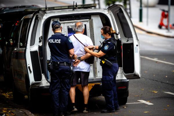 Police arrest a man for refusing to wear a face mask on the first day of a snap lockdown in Brisbane, Australia, on Jan. 9, 2021. (Patrick Hamilton/AFP via Getty Images)