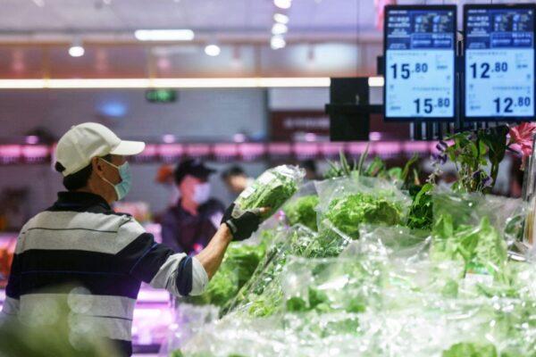 A customer shops for vegetables at a supermarket in Hangzhou, in China's eastern Zhejiang province on April 11, 2023. (STR/AFP via Getty Images)