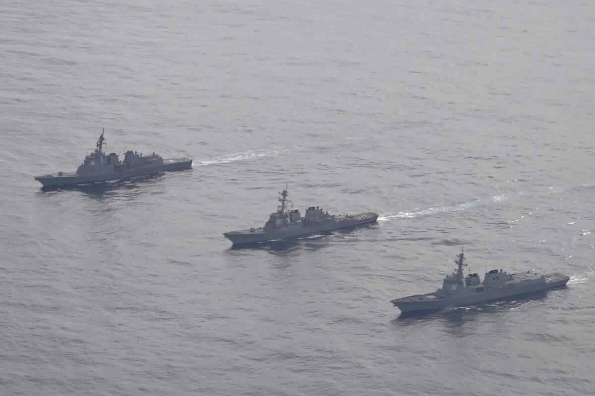 Japan Maritime Self-Defense Force's destroyer Atago (L), U.S. Navy's Arleigh Burke-class guided-missile destroyer USS Barry (C), and South Korean Navy's Aegis destroyer King Sejong the Great (R) sail during a joint missile defense drill among South Korea, the United States and Japan in the international waters of the east coast of Korean peninsular on Feb. 22, 2023. (South Korea Defense Ministry via AP)