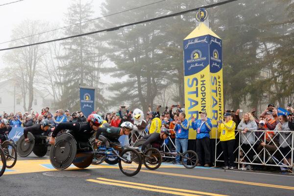 Men's wheelchair athletes Daniel Romanchuk (W1) and Marcel Hug (W2), of Switzerland, break from the starting line with others during the 127th Boston Marathon in Hopkinton, Mass., on April 17, 2023. (Mary Schwalm/AP Photo)