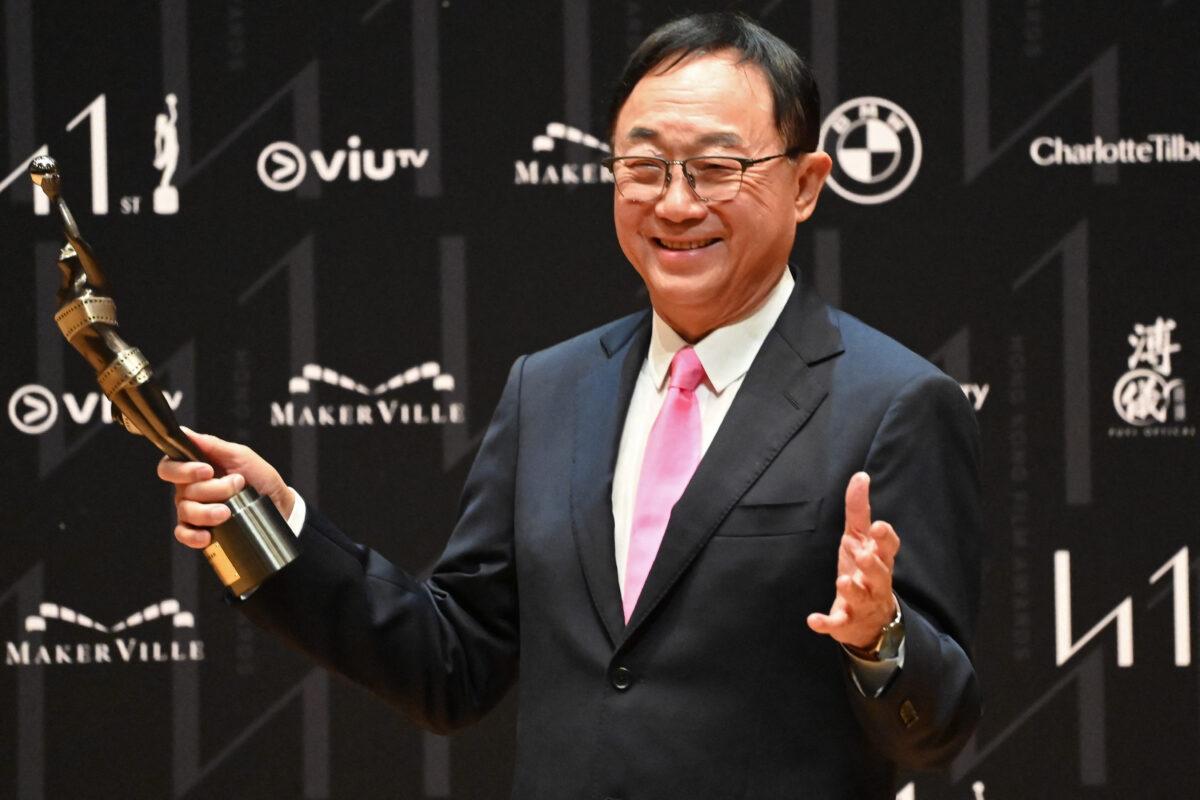 Hong Kong actor Michael Hui holds his statuette for winning the Best Supporting Actor award at the 41st Hong Kong Film awards in Hong Kong on April 16, 2023. (Peter Parks/AFP)