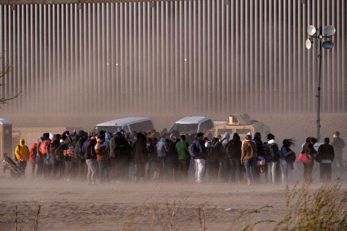 Illegal immigrants wait to be processed by U.S. border agents at the U.S.-Mexico border on March 30, 2023. (Guillermo Arias/AFP via Getty Images)