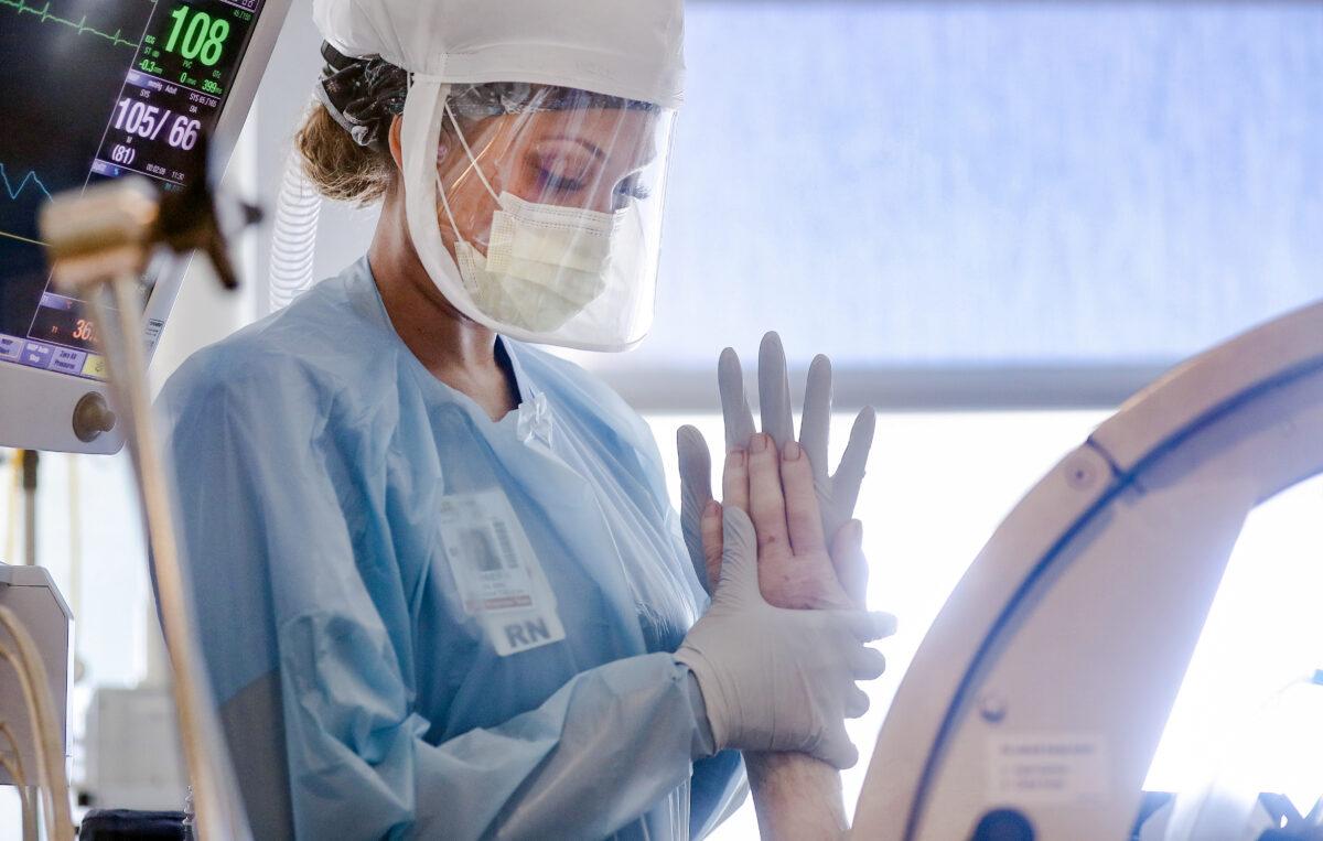 Nurse Amber Kirk wears personal protective equipment (PPE) to perform range of motion exercises on a COVID-19 patient in the Intensive Care Unit (ICU) at Sharp Grossmont Hospital amid the coronavirus pandemic in La Mesa, Calif., on May 5, 2020. (Mario Tama/Getty Images)