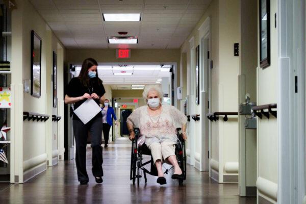 A caregiver walks with nursing home resident at a Quality Life Services facility in western Pennsylvania. (Courtesy of the Pennsylvania Health Care Association)