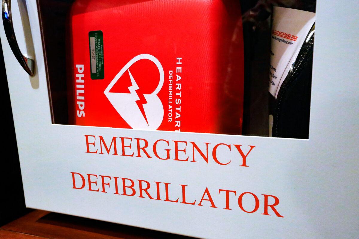 An emergency defibrillator, used to treat life-threatening conditions that affect the rhythm of the heart, hangs on the wall at the Illinois Capitol in Springfield on July 1, 2014. (AP Photo/Seth Perlman)
