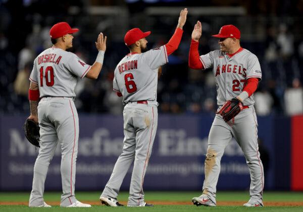 Gio Urshela (10),Anthony Rendon (6) and Mike Trout (27) of the Los Angeles Angels celebrate the win over the New York Yankees at Yankee Stadium in the Bronx borough of New York City on on April 18, 2023. (Elsa/Getty Images)