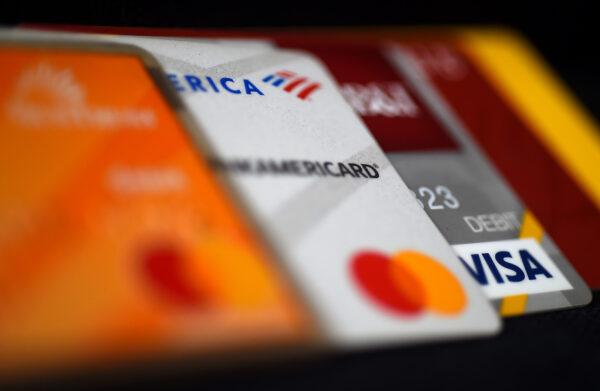 This illustration picture shows debit and credit cards arranged on a desk in Arlington, Va. on April 6, 2020. (Olivier Douliery/AFP via Getty Images)