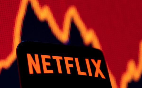 Smartphone with Netflix logo in front of a stock graph in an illustration taken on April 19, 2022. (Dado Ruvic/Illustration/Reuters)