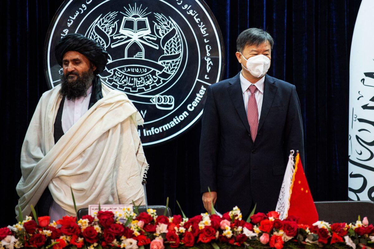 Afghanistan's acting first deputy prime minister, Abdul Ghani Baradar (L), and China's ambassador at Kabul, Wang Yu, announce an oil extraction contract with a Chinese company in Kabul on Jan. 5, 2023. (Ahmad Sahel Arman/AFP via Getty Images)