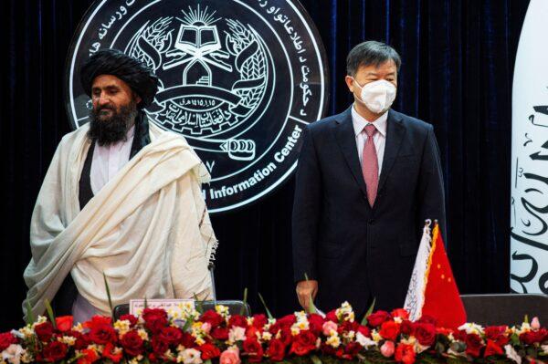 Afghanistan's acting first deputy prime minister, Abdul Ghani Baradar (L), and China's ambassador to Kabul, Wang Yu, announce an oil extraction contract with a Chinese company, in Kabul, Afghanistan, on Jan. 5, 2023. (Ahmad Sahel Arman/AFP via Getty Images)