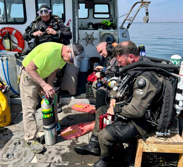 The team preparing to dive the wreck of the 92-foot attack submarine Defender on April 14, 2023, that was scuttled by the Army Corp of Engineers in 1946. (Jennifer Sellitti/Shoreline Diving Services via AP)
