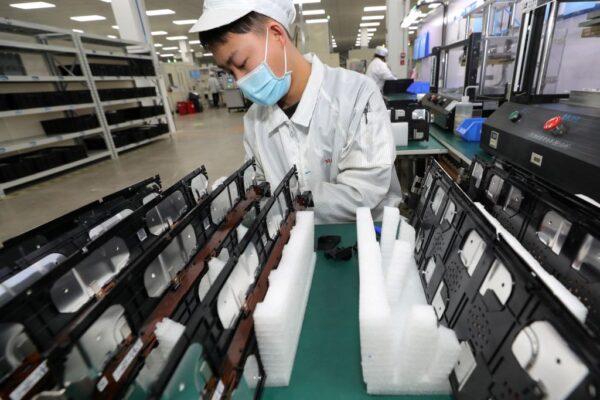 A worker at a factory for Xinwangda Electric Vehicle Battery Co. Ltd, which makes lithium batteries for electric cars and other uses, in Nanjing in China's eastern Jiangsu Province, on March 12, 2021. (STR/AFP via Getty Images)