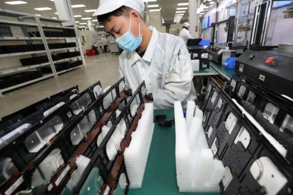 A worker at a factory for Xinwangda Electric Vehicle Battery Co. Ltd, which makes lithium batteries for electric cars and other uses, in Nanjing in China's eastern Jiangsu province on March 12, 2021. (STR/AFP via Getty Images)