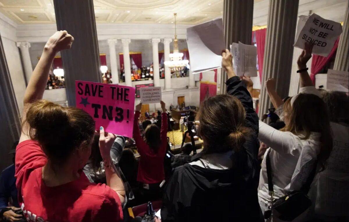 Gun control advocates raise signs in the gallery of the Tennessee House chamber in Nashville, Tenn., on April 6, 2023. (George Walker IV/AP Photo)