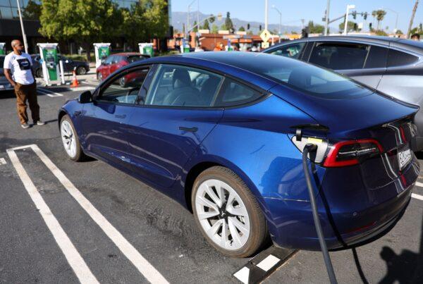 A Tesla recharges at a Tesla Supercharger station in Pasadena, Calif., on April 14, 2022. (Mario Tama/Getty Images)