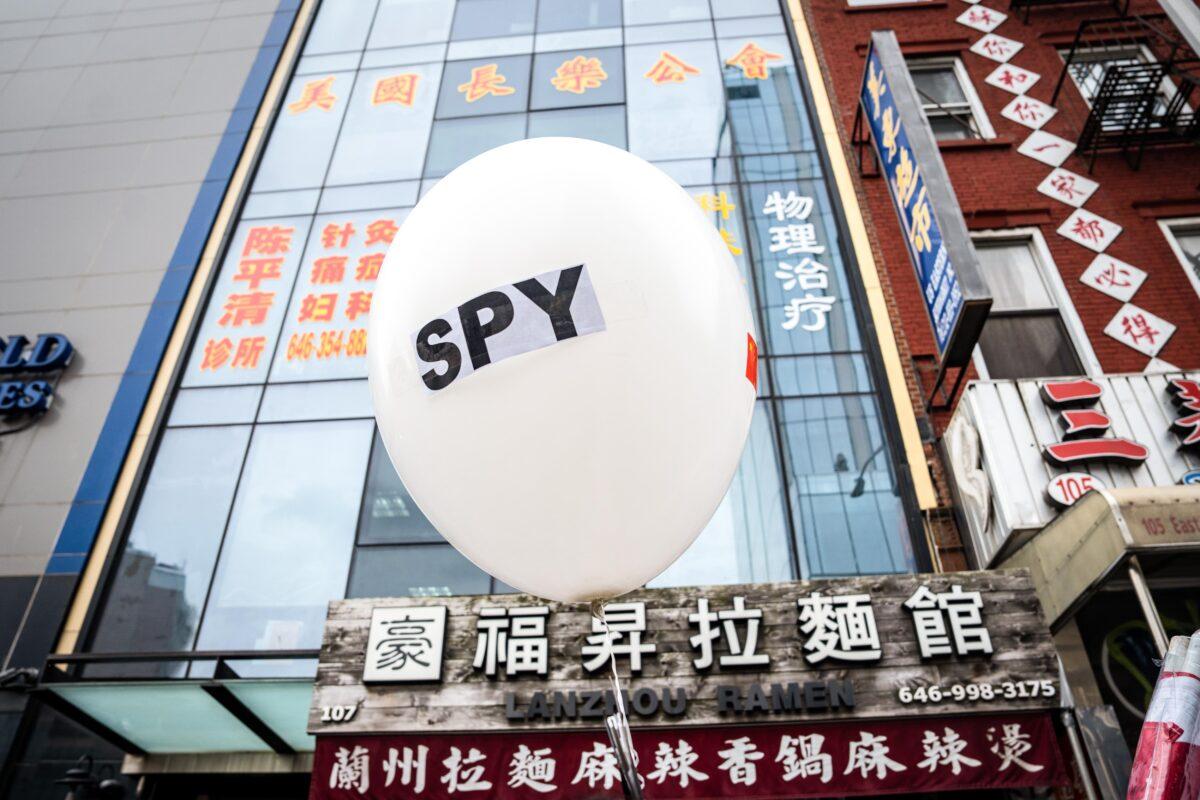 A balloon is held at a press conference and rally in front of the America ChangLe Association highlighting Beijing's transnational repression, in New York City on Feb. 25, 2023. A now-closed overseas Chinese police station is located inside the association building.(Samira Bouaou/The Epoch Times)