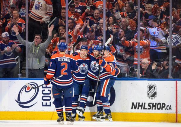 Edmonton Oilers' Evan Bouchard (2), Zach Hyman (18), Leon Draisaitl (29) and Ryan Nugent-Hopkins (93) celebrate a goal against the Los Angeles Kings during the first period of Game 2 of an NHL hockey Stanley Cup first-round playoff series in Edmonton, Alberta, Canada, on April 19, 2023. (Jason Franson/The Canadian Press via AP)