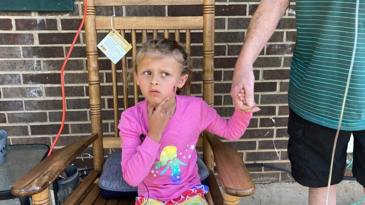 Kinsley White, 6, shows reporters a wound left on her face, in Gastonia, N.C., on April 20, 2023. (Kara Fohner/The Gaston Gazette via AP)