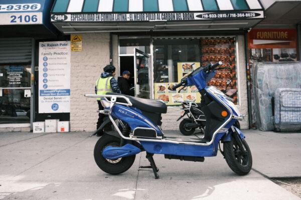 An electric scooter with a battery sits parked outside of a Bronx supermarket the day after a five-alarm fire tore through a market that fire officials are blaming on a faulty lithium-ion battery in New York City on March 6, 2023. (Spencer Platt/Getty Images)