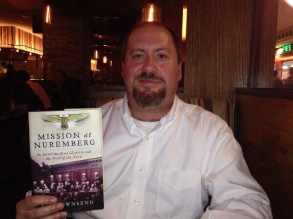 Author Tim Townsend and his book "Mission at Nuremberg: An American Army Chaplain and the Trial of the Nazis." (U.S. Army)