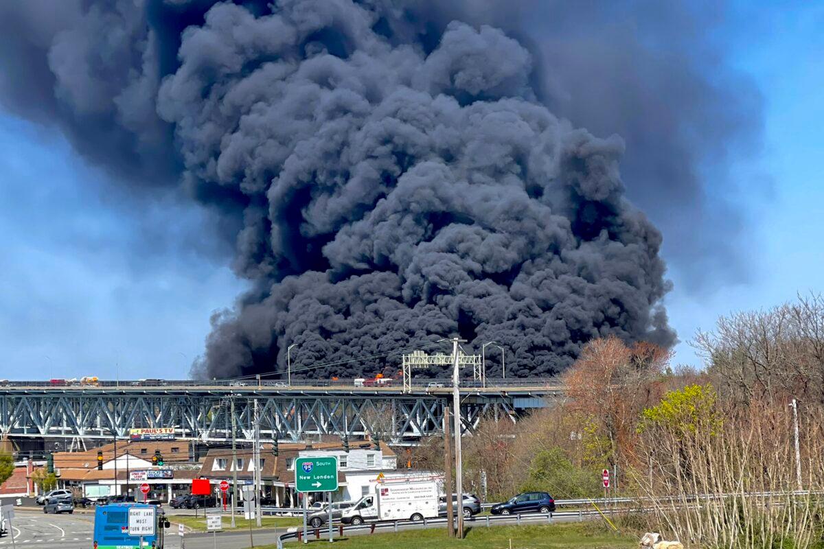 Massive plumes of smoke rise from a fire resulting from crash involving a fuel truck and a car on the Gold Star Memorial Bridge in Groton, Conn., on April 21, 2023. (Connecticut State Police via AP)