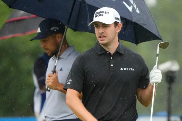 Patrick Cantlay and his teammate Xander Schauffele, behind, survey their shot on the sixth green during the second round of the PGA Zurich Classic golf tournament at TPC Louisiana in Avondale, La., on April 21, 2023. (Gerald Herbert/AP Photo)