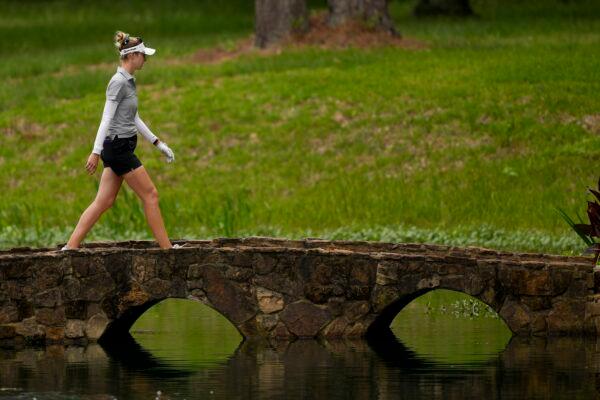 Nelly Korda walks over the bridge on the 15th hole during the second round of the Chevron Championship women's golf tournament at The Club at Carlton Woods in The Woodlands, Texas, on April 21, 2023. (David J. Phillip/AP Photo)