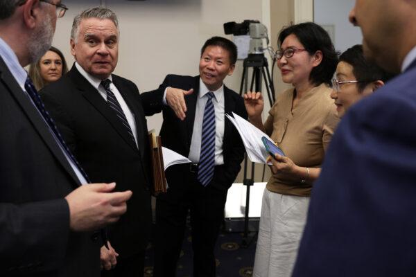 Subcommittee Chairman Rep. Chris Smith (R-N.J.) (3rd L) greets President of the China Aid Association Bob Fu (4th L), Geng He (5th L), wife of Chinese human rights attorney and dissident Gao Zhisheng, Sophie Luo (6th L), wife of Chinese human rights lawyer Ding Jiaxi, and President of the Victims of Communism Memorial Foundation Andrew Bremberg (R) prior to a hearing before the Global Health, Global Human Rights, and International Organizations Subcommittee of the House Foreign Affairs Committee at Rayburn House Office Building on Capitol Hill in Washington on April 20, 2023. (Alex Wong/Getty Images)