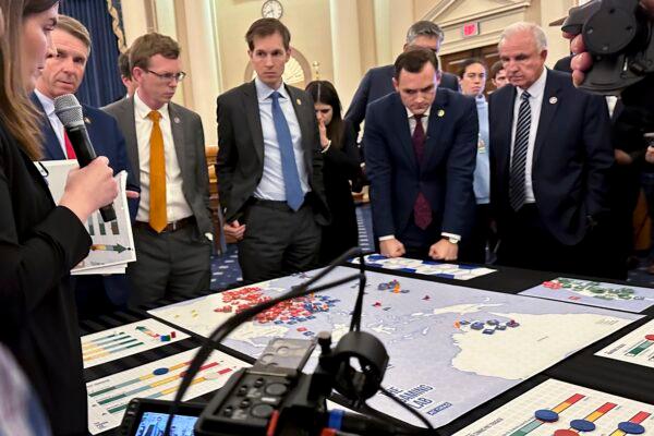 Lawmakers in a new House select committee on China gather for a tabletop war game exercise in the House Ways and Means Committee room in Washington on April 19, 2023. (Ellen Knickmeyer/AP Photo)