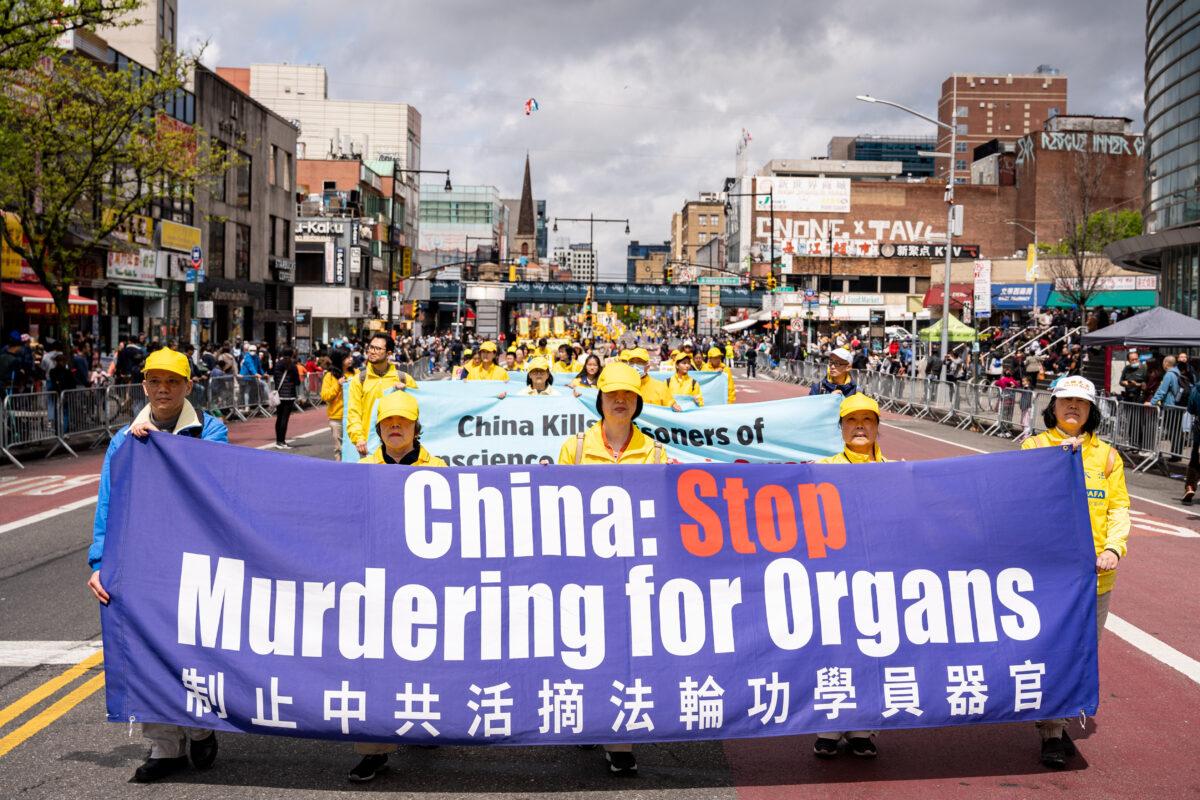 Falun Gong practitioners participate in a parade to call for an end to the Chinese Communist Party's persecution of their faith in the Flushing neighborhood of Queens, N.Y., on April 23, 2023. (Chung I Ho/The Epoch Times)