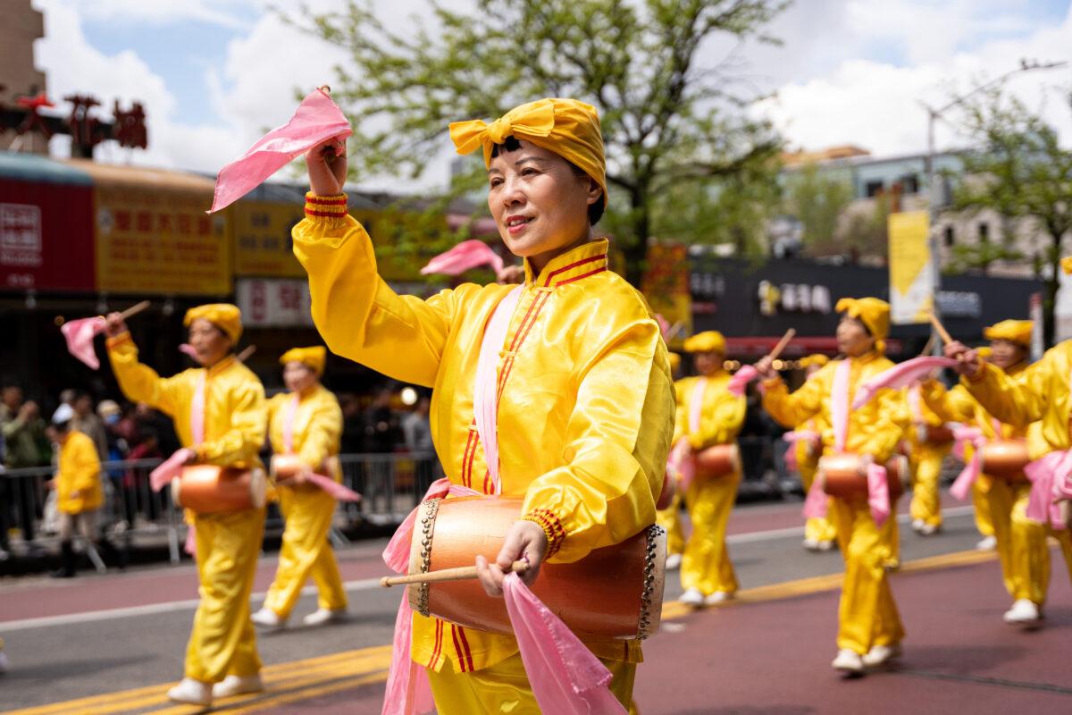 Falun Gong practitioners participate in a parade to call for an end to the Chinese Communist Party's persecution of their faith in the Flushing neighborhood of Queens, N.Y., on April 23, 2023. (Chung I Ho/The Epoch Times)