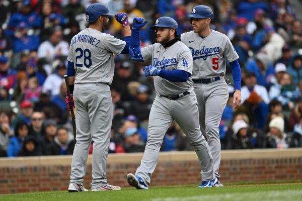 Max Muncy (13) of the Los Angeles Dodgers is congratulated by J.D. Martinez (28) after hitting a two-run home run with Freddie Freeman (5) on base in the fifth inning against the Chicago Cubs at Wrigley Field in Chicago on April 23, 2023. (Jamie Sabau/Getty Images)
