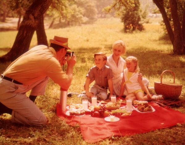 A father captures his family's happiness during a picnic, circa 1960. (FPG/Hulton Archive/Getty Images)