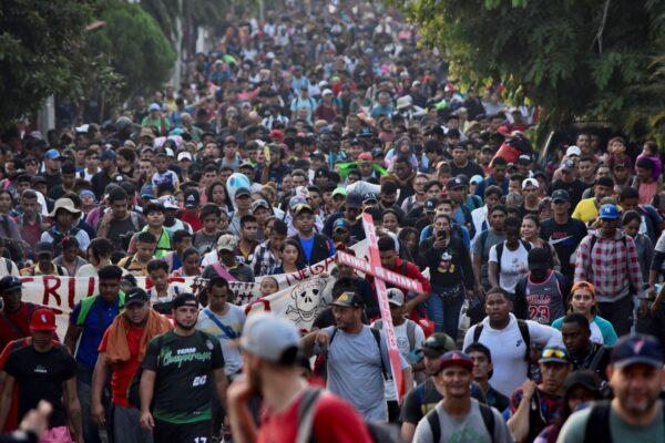 Migrants from Central and South America take part in a caravan heading toward the U.S.-Mexico border while carrying signs protesting the death of 40 migrants in last month's fire at a Mexican detention center in Tapachula, Mexico, on April 23, 2023. (AFP via Getty Images)