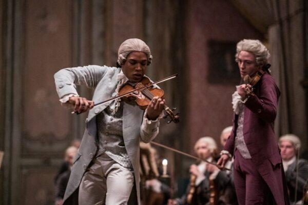 Joseph Bologne (Kelvin Harrison, Jr.) plays on stage with Wolfgang Amadeus Mozart (Joseph Prowen), in "Chevalier." (Searchlight Pictures)