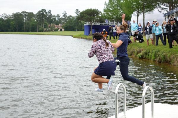 Lilia Vu (L) of the United States jumps in the water after winning in a one-hole playoff against Angel Yin (not pictured) of the United States during the final round of The Chevron Championship at The Club at Carlton Woods in The Woodlands, Texas, on April 23, 2023. (Stacy Revere/Getty Images)