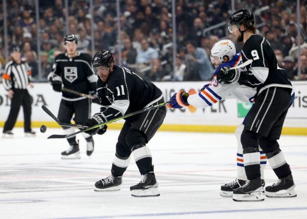 Anze Kopitar (11) of the Los Angeles Kings plays the puck away from Leon Draisaitl (29) of the Edmonton Oilers and Adrian Kempe (9) during the second period in Game Four of the First Round of the 2023 Stanley Cup Playoffs in Los Angeles on April 23, 2023. (Harry How/Getty Images)