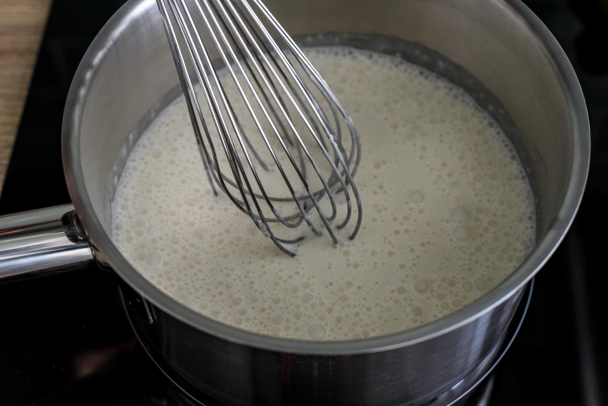 Over medium heat, whisk together the almond milk, heavy cream, almond extract, sugar, and gelatin. (Audrey Le Goff)