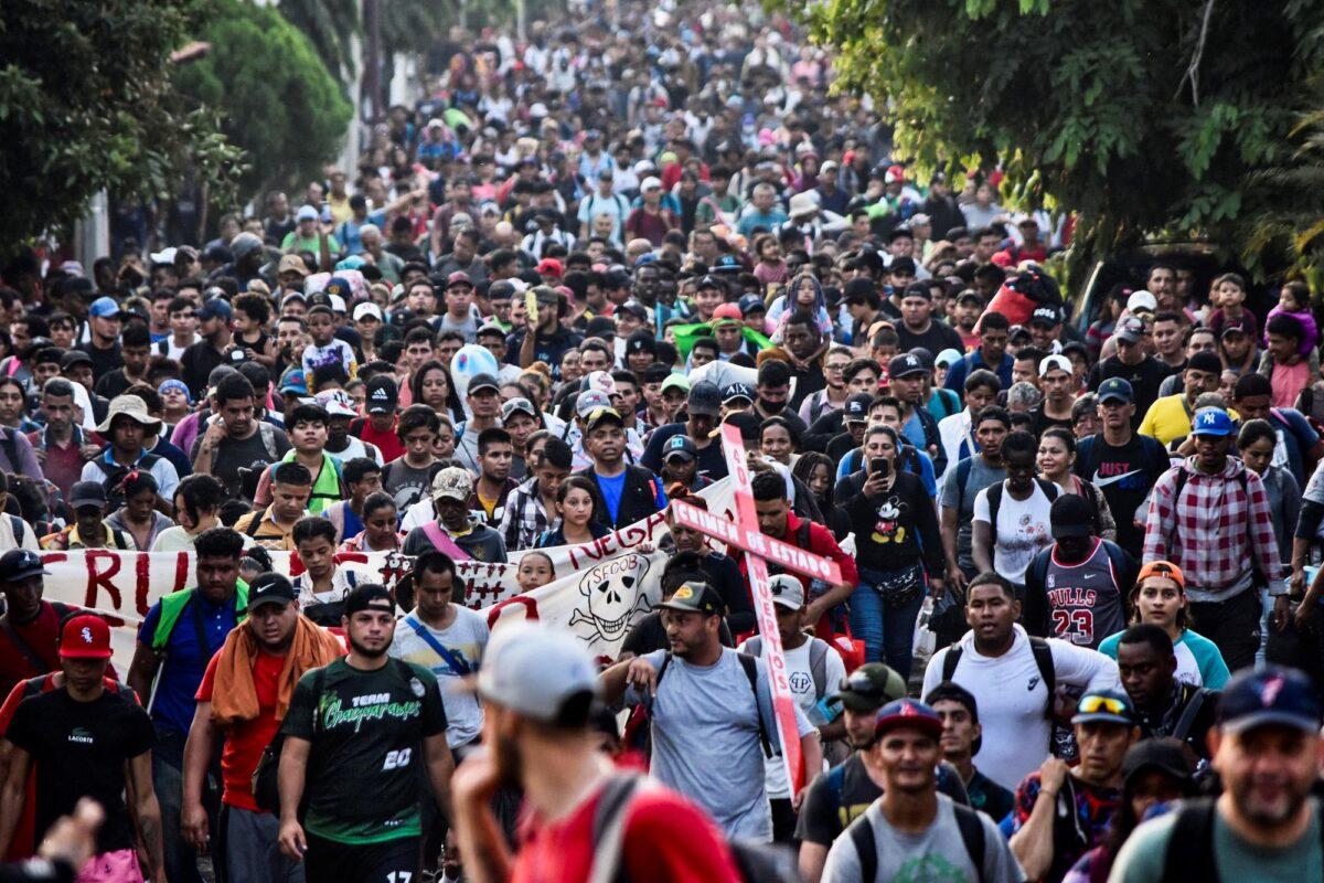 Migrants from Central and South America take part in a caravan attempting to reach the Mexico-U.S. border, while carrying out a viacrucis to protest for the death of 40 illegal immigrants in a fire at a detention center in the northern city of Juarez, in Tapachula, Chiapas state, southern Mexico, on April 23, 2023. (Stringer/AFP via Getty Images)
