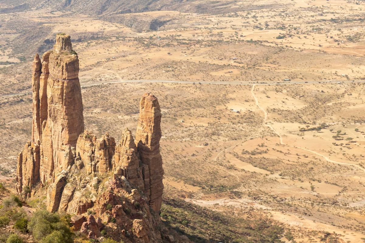 A monolithic spire towering over a valley in Tigray, Ethiopia, is home to Abuna Yemata Guh, a church hewn from the living limestone. (chiakto/Shutterstock)