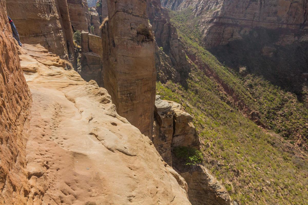 A narrow ledge leads the way to the entrance of Abuna Yemata Guh in the Tigray region, Ethiopia. (Matyas Rehak/Shutterstock)