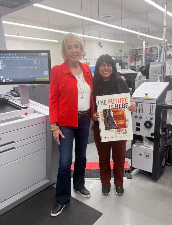 Former CEO of Corona-based Thoro Packaging Janet Steiner (L) and college student Iris Meriat stand in front of a newly donated printing press at Riverside City College in Riverside, Calif., on April 21, 2023. (Rudy Blalock/The Epoch Times)