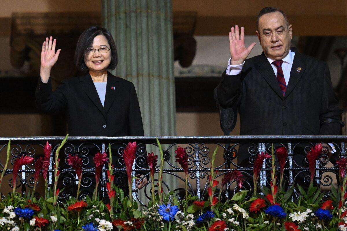 Taiwan's President Tsai Ing-wen (L) and Guatemala's President Alejandro Giammattei wave from a balcony at the Culture Palace in Guatemala City on March 31, 2023. (Johan Ordonez/AFP via Getty Images)