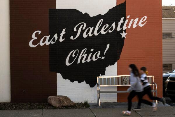 Children run past a mural in East Palestine, Ohio, on March 7, 2023. (Matt Rourke/AP Photo)