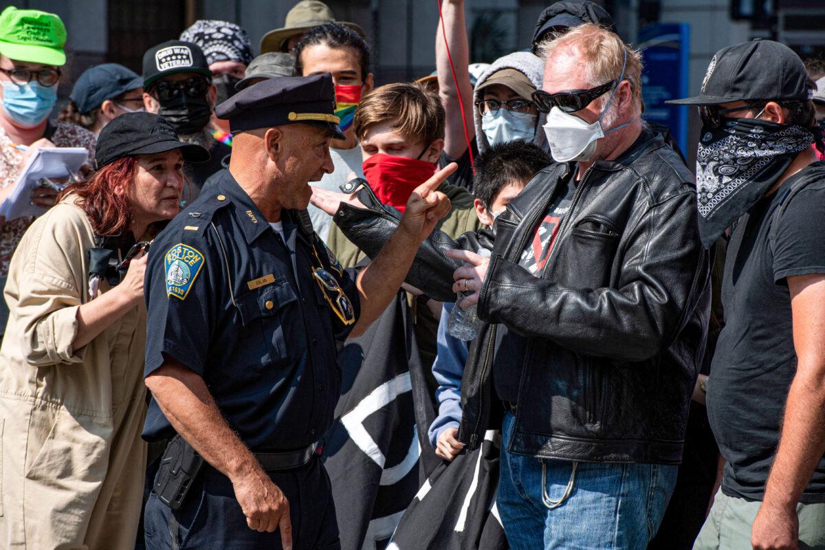 Police face pro-transgender protesters outside of Boston Children's Hospital in Boston, Massachusetts, on Sept. 18, 2022. (Joseph Prezioso/AFP via Getty Images)