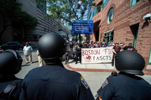 Police face pro-transgender protesters outside of Boston Children's Hospital in Boston, Massachusetts, on Sept. 18, 2022. (JOSEPH PREZIOSO/AFP via Getty Images)