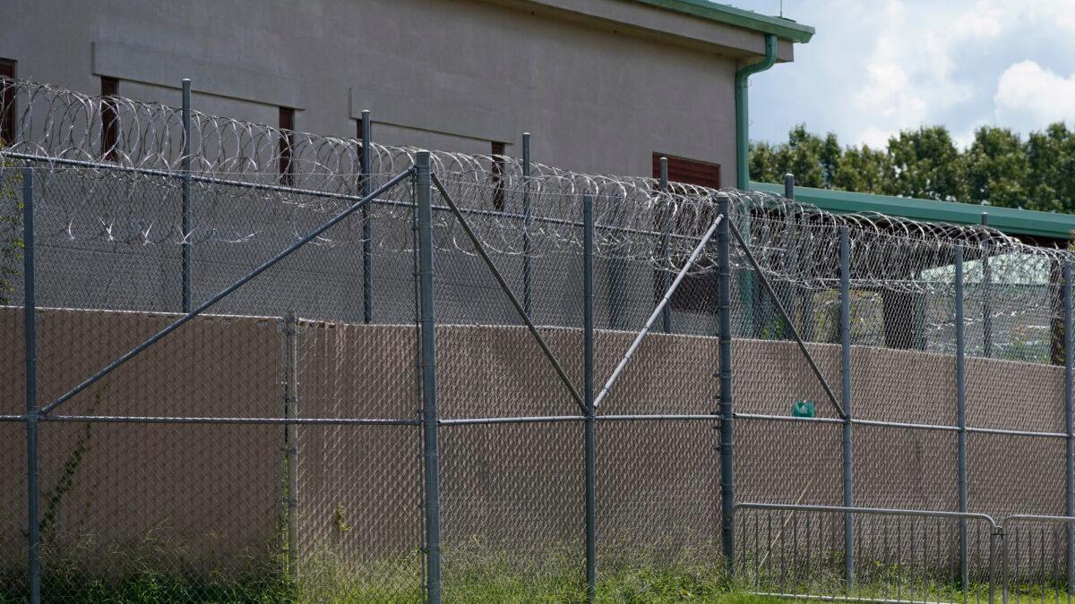 Rolls of razor wire line the top of the security fencing at the Raymond Detention Center in Raymond, Miss., on Aug. 1, 2022. (Rogelio V. Solis/AP Photo)