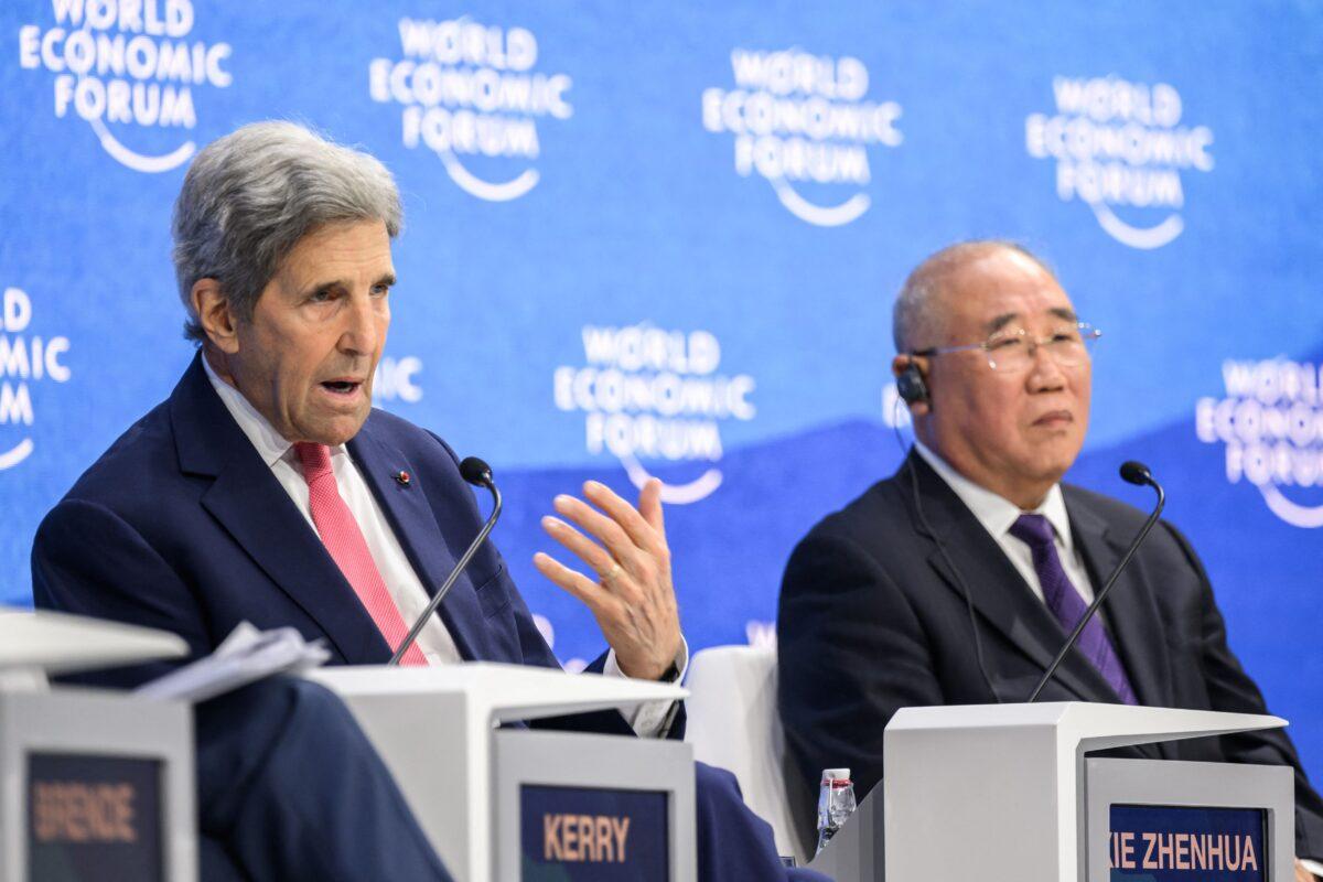 U.S. climate envoy John Kerry (L) gestures as he speaks next to China's special climate envoy, Xie Zhenhua (R), during a session at the World Economic Forum annual meeting in Davos, Switzerland, on May 24, 2022. (Fabrice Coffrini/AFP via Getty Images)