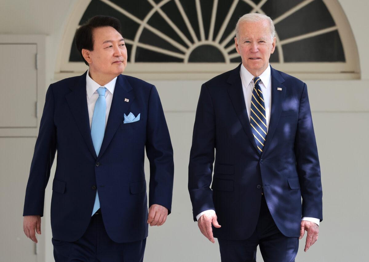 U.S. President Joe Biden (R) and South Korean President Yoon Suk-yeol walk on the colonnade as they make their way to a meeting in the Oval Office at the White House, in Washington, on April 26, 2023. (Win McNamee/Getty Images)
