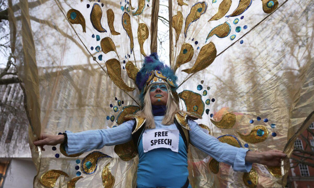A woman with a sign saying "free speech" as she prepares to take part in a protest against Julian Assange's continued imprisonment, in London, on Feb. 11, 2023. (Dan Kitwood/Getty Images)